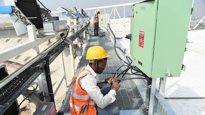 Electricians at the construction site of the world's largest cricket stadium in Gujarat, India, which is expected to be completed by March. AFP