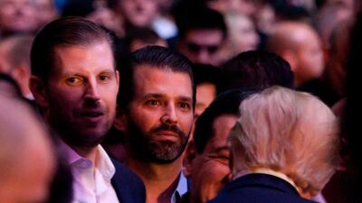 Eric Trump, left, Donald Trump Jr., centre, join their father Donald Trump to watch UFC 244. AFP