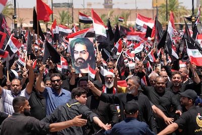 Supporters of Shia cleric Muqtada al-Sadr, wave flags as they take part in a demonstration supporting Iraqi Prime Minister Ali al-Zaidi’s government-led anti-corruption campaign, in Najaf. AFP