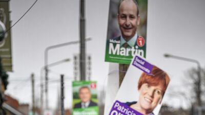 A man walks past election placards near Nagle Hall as Irelands national election takes place in Cork, Ireland. Getty Images
