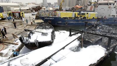 Two fishing dhows were destroyed after fire ripped through them in the port of Mushairef in Ajman. Jeffrey E Biteng / The National