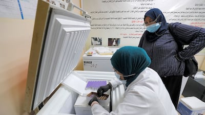 A medical worker unpacks a box of Pfizer-BioNTech coronavirus vaccine at a vaccination centre in Iraq's capital, Baghdad.