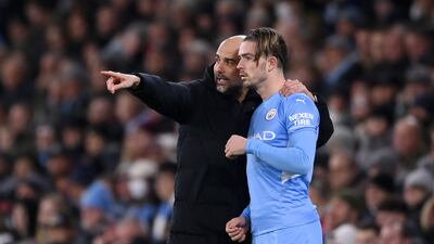 Pep Guardiola gives instructions to Jack Grealish as he prepares to come on as a sub against Brentford. Getty