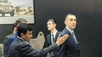 Inkas's chief executive Ulugbekhon Maksumov shows a customer around the stand. Olga Voronova / Inkas