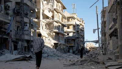 A Syrian man walks past a heavily damaged building following air strikes on rebel-held eastern areas of Aleppo on September 24, 2016. AFP