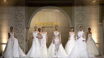 Czech top model Karolina Kurkova (C) taking the caltwalk during the 50th anniversary of Pronovias fashion show in Barcelona, northeastern Spain, 09 May 2014. EPA