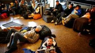 Passengers wait at the airport during an expected delay. You can insure yourself for a single trip or an entire year.