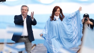 Mr Fernandez left, greets his supporters besides former Argentinian president Cristina Fernandez de Kirchner. He has said previously the country won't default on its debt if elected. EPA.