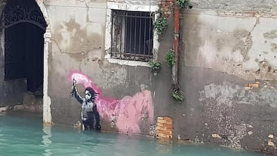 A view of Banksy's migrant child mural, half-submerged in high water in Venice, November 2019. EPA