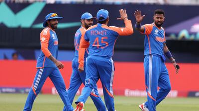 India bowler Hardik Pandya celebrates with teammates after dismissing USA batsman Aaron Jones. AFP