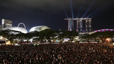 Fans arrive at The Padang to see pop-star Ariana Grande perform as part of the 2017 Formula 1 Singapore Grand Prix. Brendon Thorne / Singapore GP via Getty Images
