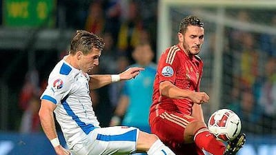 Spain's Koke, right, and Slovakia's Peter Pekarik fight for a ball during Euro 2016 qualifing football match between Slovakia and Spain in northern Slovak town of Zilina on October 9, 2014. AFP PHOTO / JOE KLAMAR
