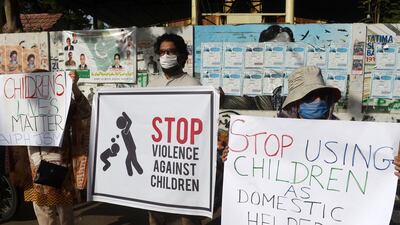 Activists carry placards during a protest against child labour and violence against children, Karachi, June 8. Asif Hassan / AFP
