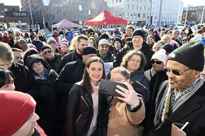 Finland's Prime Minister Sanna Marin poses with supporters during a rally in Vantaa on Friday. AFP