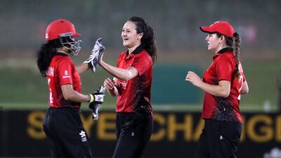 Mariko Hill of Hong Kong, centre, celebrates after taking the wicket of UAE's Chaya Mughal.