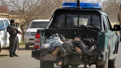 Afghan victims of a suicide attack, which occurred on Afghan army recruitment center are carried on the back of a police vehicle in Kunduz, north of Kabul, Afghanistan on Monday, March 14, 2011. A suicide bomber posing as an army volunteer struck an Afghan army recruitment center in the northern Kunduz province on Monday afternoon, killing at least 33 people, Afghan officials said. (AP Photo/Fulad Hamdard) *** Local Caption *** XMS104_Afghanistan_.jpg