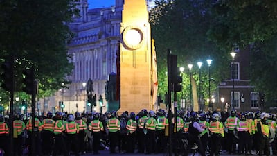 Police officers surround the cenotaph in Whitehall, London, during a Black Lives Matter protest rally on Sunday. AP