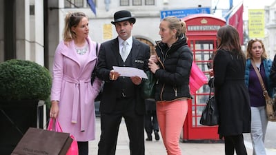 Oxford Street ambassador Abdel Miloudi helping shoppers in New Bond Street, London. Stephen Lock for The National