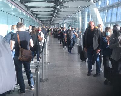 Passengers in a corridor at Heathrow Airport on Wednesday morning after passport scanners were out of order. George Zarkadakis / Twitter