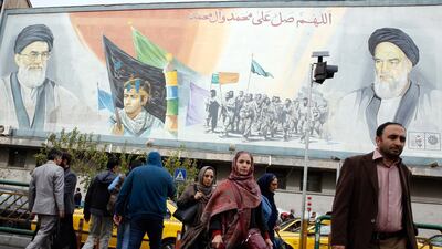 Iranians walk past a mural depicting Iranian supreme leader Ayatollah Ali Khamenei and the late Iranian supreme leader Ayatollah Ruhollah Khomeini on a Tehran street. EPA/Abedin Tahekenareh