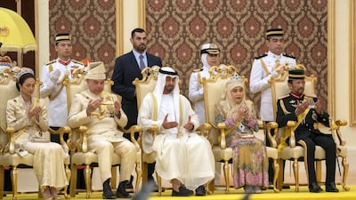 Sheikh Mohamed prays at the coronation of Malaysia's new king Sultan Abdullah.