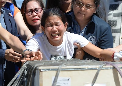 Jessica Demafelis, sister of Filipina maid Joanna Demafelis, whose body was found inside a freezer in Kuwait, is distraught as the coffin arrives in Manila in 2018. AFP