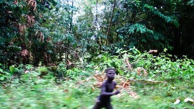 A boy from the Jarawa tribe approaches a tourist on the trunk road.
