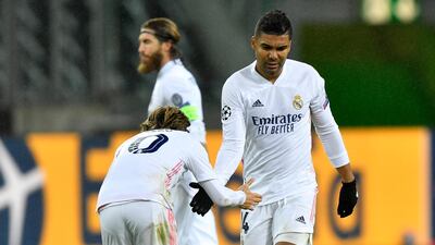 Real Madrid's scorer Casemiro, right, shakes hands with Luka Modric. AP