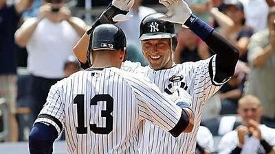 Alex Rodriguez celebrates with Derek Jeter, after hitting the 600th home run of his career in the first inning against the Toronto Blue Jays at Yankee Stadium yesterday.
