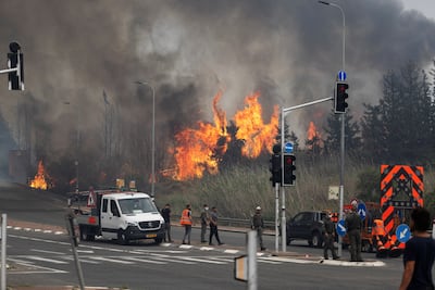 Israeli security and rescue personnel work near Latrun against wildfires that broke out in central Israel on Wednesday. Reuters