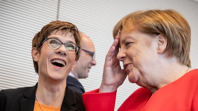 Leader of Germany's conservative Christian Democratic Union (CDU) party Annegret Kramp-Karrenbauer (L) chats with Chancellor Angela Merkel before a session of the CDU/CSU parliamentary group meeting on May 14, 2019 in Berlin. AFP