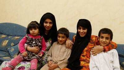 Zahra Ali Mohammad(C) from the UAE, who underwent open heart surgery in January, siits with her siblings Fatima(2nd L), Hezaa and Jumaa, and niece Ghaliya, in their living room.
