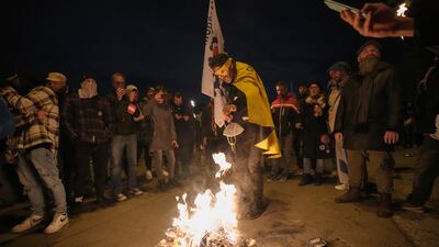 Protesters burn face masks. AP Photo
