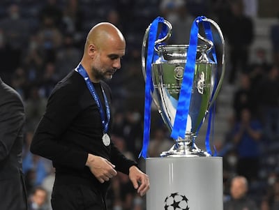 Manchester City manager Pep Guardiola walks past the Champions League trophy after defeat to Chelsea. Reuters