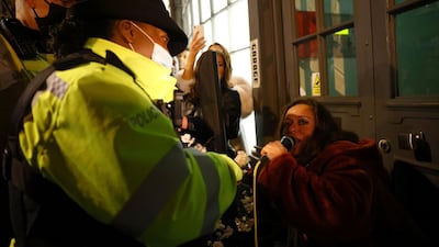 Police officers speak to people on a street in Soho. Reuters
