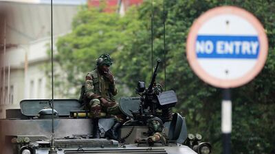 Soldiers sit on a military vehicle parked on a street in Harare, Zimbabwe, on November 16, 2017. AP