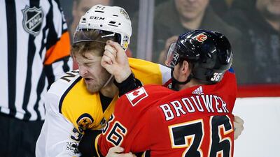 Nashville Predators' Austin Watson fights with Calgary Flames' Troy Brouwer during the second period of an NHL hockey game in Calgary, Alberta. Jeff McIntosh / The Canadian Press via AP