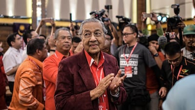 Former Malaysian prime minister Mahathir Mohamad applauds after he was elected as the opposition's prime ministerial candidate on Sunday / AFP
