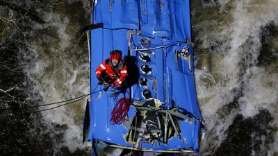 A fireman works to rescue victims of a bus that fell into Lerez river in Cerdedo-Cotobade, Pontevedra, in the province of Galicia, Spain 25 December 2022. The bus, coming from the prison of Monterroso in Lugo, plunged into the water after getting off the road while crossing a bridge. Two people died and three other are missing. EPA / LAVANDEIRA JR