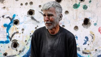 An elderly Palestinian man stands in front of a building hit by an Israeli strike on the Shujaiya neighbourhood of Gaza city. AFP