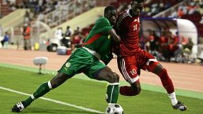 Oman's creative midfielder Fawzi Bashir, right, fights for the ball with Mohammed Coly of Senegal during their friendly in Muscat on Dec 22.