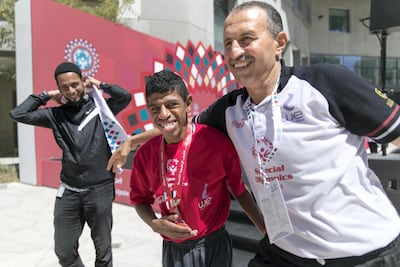 Maher Helmy from Egypt embraces his coach after winning third place for the 50m Freestyle swim. Reem Mohammed / The National