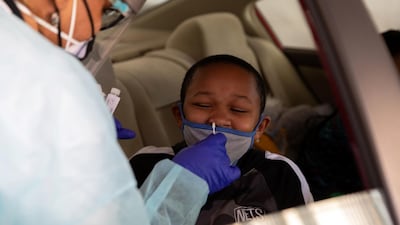 A nurse administers a coronavirus test at a drive-through centre targeting underserved communities on Martin Luther King Day in Philadelphia, Pennsylvania. Reuters