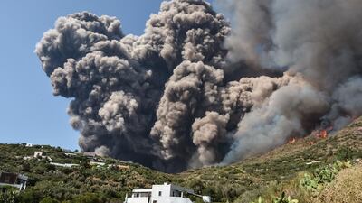 Smoke billows and flammes propaqate accross the hillside neqr houses after the Stromboli volcano erupted on the Stromboli island, north of Sicily. A volcano on the Italian island of Stromboli erupted dramatically killing a hiker and sending tourists fleeing into the sea. AFP