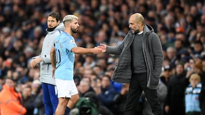 Guardiola congratulates Aguero as he substitutes the Argentine following his hat-trick. Getty