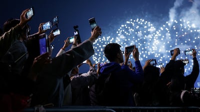 Revellers in Hong Kong photograph the New Year fireworks over Victoria Harbour. Reuters