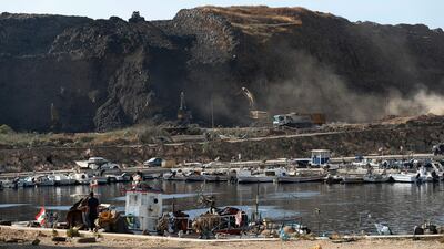 Bulldozers remove waste from a landfill to be moved to a new land reclamation site in Bourj Hammoud east of Beirut, Lebanon. Hussein Malla / AP
