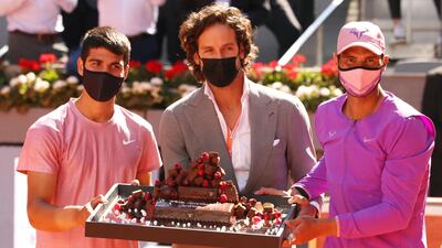 Carlos Alcaraz, left, is presented with a birthday cake by tournament director Feliciano Lopez ahead of his match against Rafael Nadal. Getty