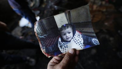 A photograph of 18-month-old Ali Dawabsheh in what was his home in the West Bank village of Douma. The Palestinian infant was killed after Jewish settlers set his home alight in an unprovoked attack (EPA/ALAA BADARNEH)