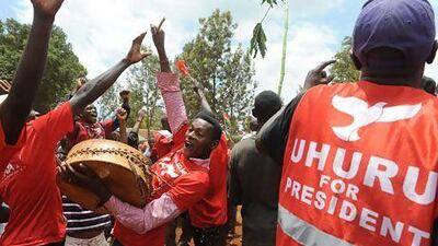 Supporters of Uhuru Kenyatta celebrate upon learning of his victory in Kenya's presidential elections on Saturday. Simon Maina / AFP